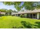 Spacious backyard with well-maintained lawn and mature trees offering shade and privacy at 2510 Laurelwood Dr # 5B, Clearwater, FL 33763