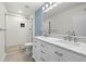A bathroom with double sinks, a large mirror and a shower with white tiles at 2510 Laurelwood Dr # 5B, Clearwater, FL 33763