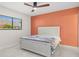This bedroom features a ceiling fan and a large window for natural light at 2510 Laurelwood Dr # 5B, Clearwater, FL 33763
