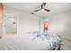 This bedroom features a ceiling fan and adjoins a bathroom with a glass door at 2510 Laurelwood Dr # 5B, Clearwater, FL 33763