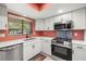 Modern kitchen featuring stainless steel appliances, white cabinetry, and quartz countertops at 2510 Laurelwood Dr # 5B, Clearwater, FL 33763