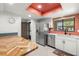 Modern kitchen featuring stainless steel appliances and breakfast bar with white cabinetry at 2510 Laurelwood Dr # 5B, Clearwater, FL 33763