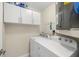 A well-lit laundry room with a washer, dryer, and storage cabinets at 2510 Laurelwood Dr # 5B, Clearwater, FL 33763