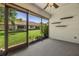 The screened patio has a view of the lush backyard, and a ceiling fan at 2510 Laurelwood Dr # 5B, Clearwater, FL 33763