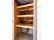 Compact storage unit with wooden shelves providing organizational solutions for household items at 2510 Laurelwood Dr # 5B, Clearwater, FL 33763