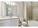 Bathroom with white cabinets, quartz countertop and a tub with shower at 2603 Wise River Ln, Zephyrhills, FL 33541