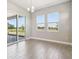 Bright dining room with large windows and sliding glass doors leading to the backyard at 2603 Wise River Ln, Zephyrhills, FL 33541