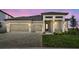 Stunning exterior elevation showcasing a well-maintained lawn and a two car garage in a serene setting at 2603 Wise River Ln, Zephyrhills, FL 33541