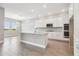 Bright kitchen featuring white cabinets, modern appliances, and a central island, perfect for entertaining at 2603 Wise River Ln, Zephyrhills, FL 33541