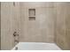 Close-up of a tiled shower with built-in shelves at 2603 Wise River Ln, Zephyrhills, FL 33541
