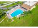 An aerial view of the sparkling pool and sundeck with palm trees at 2928 Feather Dr, Clearwater, FL 33759