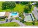 Aerial view of community pool, shuffleboard and surrounding landscaping at 2928 Feather Dr, Clearwater, FL 33759