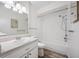 Clean bathroom showcasing a shower-tub combination and a classic single-sink vanity with a bright mirror at 2928 Feather Dr, Clearwater, FL 33759