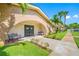 Inviting building entrance with benches, landscaping, and a charming arched entryway at 2928 Feather Dr, Clearwater, FL 33759