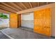 Carport storage with large plywood doors, shelving and pegboard at 2928 Feather Dr, Clearwater, FL 33759