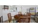 Well-lit dining space with a wooden table and four chairs open to other living spaces at 2928 Feather Dr, Clearwater, FL 33759