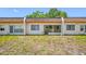 Rear exterior view of the home with a glass door and windows at 2928 Feather Dr, Clearwater, FL 33759