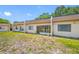 Townhome exterior with sliding glass doors, windows, and grassy lawn at 2928 Feather Dr, Clearwater, FL 33759
