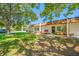 Inviting townhome exterior with lush lawn and shaded seating area at 2928 Feather Dr, Clearwater, FL 33759