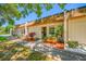 Townhome front exterior with garden beds and shaded bench at 2928 Feather Dr, Clearwater, FL 33759