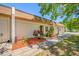 Exterior view of a cozy single-story house, showcasing lush landscaping and a walkway leading to the front entrance at 2928 Feather Dr, Clearwater, FL 33759