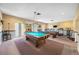 Spacious game room with pool tables, exercise equipment, and comfortable seating for recreation and leisure at 2928 Feather Dr, Clearwater, FL 33759
