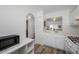 Bright kitchen includes laminate flooring, white cabinetry, sink and a view to dining area at 2928 Feather Dr, Clearwater, FL 33759