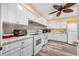Charming kitchen featuring modern appliances, white cabinetry, and wood-style flooring at 2928 Feather Dr, Clearwater, FL 33759