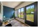 Enclosed lanai with natural light and view of green space offers serene relaxation and enjoyment at 2928 Feather Dr, Clearwater, FL 33759
