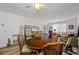 Spacious living room with wood-look floors, ceiling fan, and ample seating, with access to the outdoors at 2928 Feather Dr, Clearwater, FL 33759
