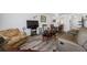 Open-concept living room with natural light and hardwood floors for entertaining or relaxation at 2928 Feather Dr, Clearwater, FL 33759