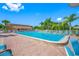 Community pool with lounge chairs around and tall palm trees in the distance at 2928 Feather Dr, Clearwater, FL 33759
