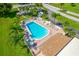 Aerial view of the community pool surrounded by lounge chairs and a recreation area at 2928 Feather Dr, Clearwater, FL 33759