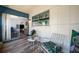This sunroom offers wood-look floors and white paneled walls with easy access to the living room through sliding doors at 2928 Feather Dr, Clearwater, FL 33759