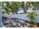 Backyard with white fence, palm tree and mature foliage providing serene outdoor experience at 3202 Cullendale Dr, Tampa, FL 33618