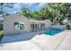 Home with swimming pool surrounded by concrete deck and a covered porch is perfect for outdoor enjoyment at 3202 Cullendale Dr, Tampa, FL 33618
