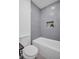 Modern bathroom featuring sleek, gray tile and storage niche for bathroom essentials at 3202 Cullendale Dr, Tampa, FL 33618