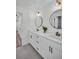 Bathroom featuring double vanity, black accents, sleek mirrors, and modern lighting at 3202 Cullendale Dr, Tampa, FL 33618