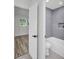 Stylish bathroom with gray tiled shower and modern fixtures, adjacent to a sunny bedroom at 3202 Cullendale Dr, Tampa, FL 33618