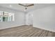 Bright bedroom featuring a ceiling fan, hardwood floors, and ample natural light at 3202 Cullendale Dr, Tampa, FL 33618