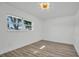 Inviting bedroom with wood-look floors, modern lighting fixture, and a large window at 3202 Cullendale Dr, Tampa, FL 33618