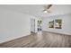 Sunlit bedroom with wood-look flooring, ceiling fan, and views of the pool area at 3202 Cullendale Dr, Tampa, FL 33618