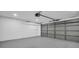 Spacious garage featuring sealed concrete flooring, bright lighting and an automatic garage door at 3202 Cullendale Dr, Tampa, FL 33618