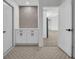 Hallway with stylish cabinets, gray accent wall, and decorative flooring creates a welcoming transitional space at 3202 Cullendale Dr, Tampa, FL 33618
