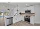 Bright, modern kitchen features stainless steel appliances, white cabinets, and sleek countertops at 3202 Cullendale Dr, Tampa, FL 33618