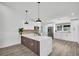 Modern kitchen featuring white cabinetry, stainless steel appliances, and a large island with a waterfall countertop at 3202 Cullendale Dr, Tampa, FL 33618
