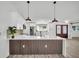 Bright kitchen showcases white cabinets, pendant lighting, stainless appliances, and a waterfall countertop island at 3202 Cullendale Dr, Tampa, FL 33618