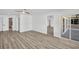 Spacious living room featuring light wood floors, white walls, and natural light from the patio doors at 3202 Cullendale Dr, Tampa, FL 33618