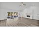 Open living room with luxury vinyl floors, shiplap fireplace and access to the pool area at 3202 Cullendale Dr, Tampa, FL 33618