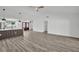 Open concept living room and kitchen with wood-look flooring, lots of natural light, and modern ceiling fan at 3202 Cullendale Dr, Tampa, FL 33618